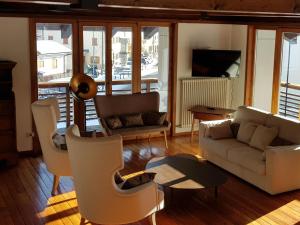 a living room with a couch and chairs at Apartment mit Balkon by Interhome in Padola