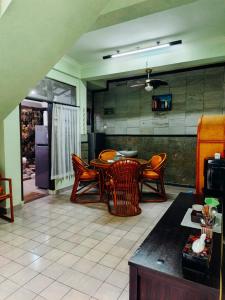 a kitchen with a table and chairs in a room at Widi House in Nusa Dua