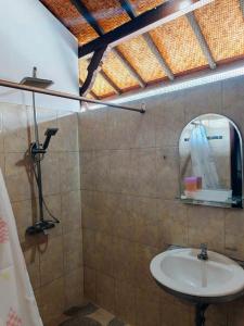 a bathroom with a sink and a mirror at Widi House in Nusa Dua +9 photos
