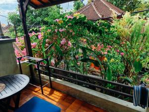 a balcony with a bunch of flowers and plants at Widi House in Nusa Dua