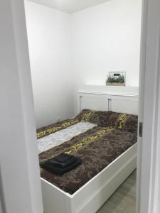 a small bed in a room with at Mini Comfort House Udine in Udine