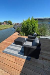 a patio with two couches on a wooden deck at Apartment Tami by Interhome in Wervershoof