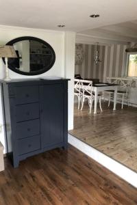 a room with a blue dresser and a dining room at Apartment Tami by Interhome in Wervershoof