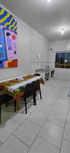 a kitchen with a table and a painting on the wall at pousada Adriane in Rio do Sul