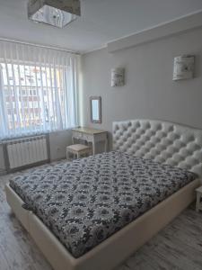 a bedroom with a large bed in a room with a window at Family Apartment Nida in Nida +28 photos