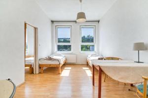 a room with a bed and two windows at Dusan Apartments in Orlová