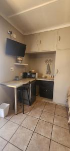 a kitchen with a table and a counter top at RoomsAtRoseAve19 in Kuruman +14 photos
