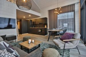 a living room with a couch and a table at Riekko Lodge in Äkäslompolo