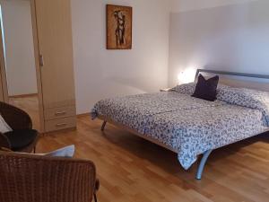 a bedroom with a bed with a blue comforter at Apartment by Interhome in Łukta