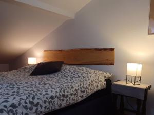 a bedroom with a bed and two lamps on tables at Apartment by Interhome in Łukta +11 photos