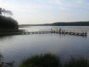 a dock in the middle of a body of water at Apartment by Interhome in Łukta