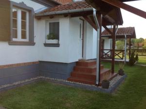 a house with a gazebo in the yard at Apartment by Interhome in Łukta +13 photos
