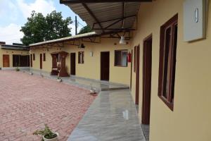 an empty courtyard of a building with a brick sidewalk at Infinity 555 Lodge in Lusaka +12 photos