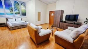 a living room with two couches and a flat screen tv at Hostel CANTO in Ruse