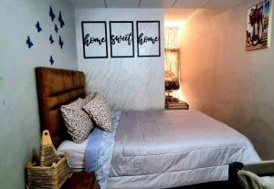 a bedroom with a bed and some pictures on the wall at Apprt Ennakhil 1 in El Jadida