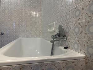 a bathroom with a white tub and a sink at il nuvoloso in Città della Pieve