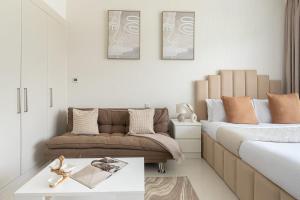 a living room with two beds and a coffee table at Frank Porter - Carson A in Dubai Marina