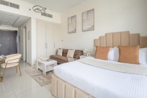 a bedroom with a large bed and a living room at Frank Porter - Carson A in Dubai Marina