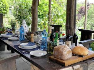 a table with bottles of wine and bread on it at La Balconata in Bagni di Lucca