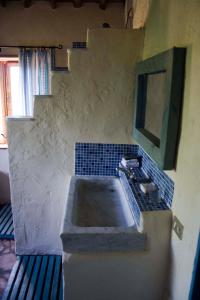 a bathroom with a sink and a mirror and stairs at La Balconata in Bagni di Lucca +37 photos