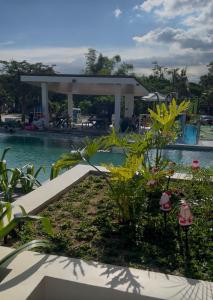 a pool with a pavilion next to a resort at Antara Condomium 2 studio unit in Talisay +5 photos