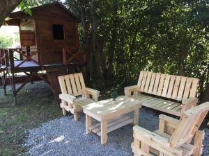 two wooden benches and a picnic table in a yard at Ayma in Chascomús