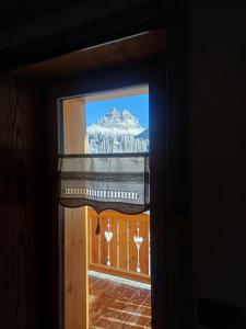 a view of a mountain through a window at Alla Vecchia Dogana in Misurina