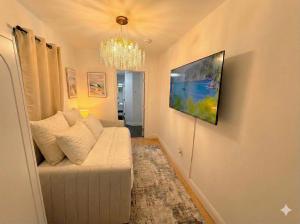 a living room with a couch and a painting on the wall at Comfortable 2BR & 2 Bath Apt in Downtown NYC in New York
