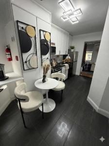 a kitchen with chairs and a table and a table and a kitchen at Comfortable 2BR & 2 Bath Apt in Downtown NYC in New York