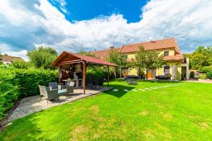 a house with a gazebo in a yard at Třeboňské Apartmány in Třeboň