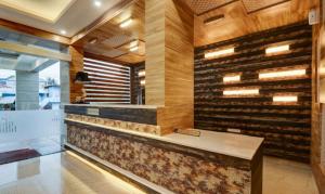 a wine tasting room with a wall of wine bottles at Hotel Hill Palace in Jāmb