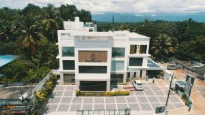 an aerial view of a white building next to a pool at Hotel Hill Palace in Jāmb