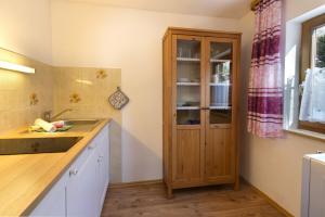 a kitchen with a sink and a wooden cabinet at Bergleuchten -403- in Krün