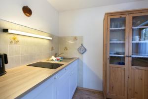 a kitchen with a sink and a wooden cabinet at Bergleuchten -403- in Krün