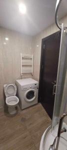 a small bathroom with a toilet and a sink at Tribu in Bakuriani