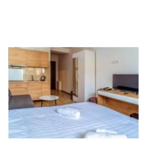 a bedroom with a blue bed and a kitchen at Tribu in Bakuriani