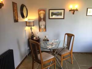 a dining room with a glass table and two chairs at Artie's Lodge in Windermere