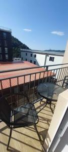 a balcony with a table and chair on a building at Tribu in Bakuriani
