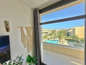 a room with a window with a view of a pool at View Pool Apartment, Two Rooms in El Gouna +7 photos