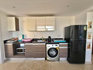 a kitchen with a refrigerator and a washing machine at View Pool Apartment, Two Rooms in El Gouna
