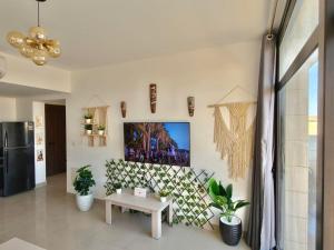 a living room with a table and a picture on the wall at View Pool Apartment, Two Rooms in El Gouna