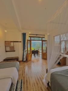 a bedroom with two beds and a room with a table at Eden View Ella - Tour options in the area in Ella