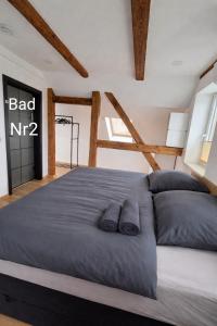 a bedroom with a bed with two pillows on it at Ferienwohnung NR4 DG Klima in Großräschen +11 photos