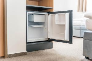 a white refrigerator with its door open in a room at Formanka Hanušovice in Hanušovice