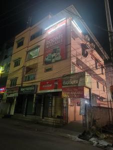 a building with signs on the side of it at Hotel Homestay-Bhimavaram in Bhīmavaram