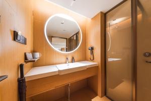 a bathroom with a sink and a mirror at JI Hotel Beijing Station in Beijing +17 photos