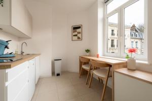 a kitchen with a table and a window at Le Cocoon Studio 2 voyageurs in Arras +5 photos