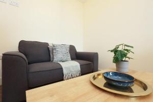 a living room with a couch and a bowl on a table at The Swansea Central Hall 1 Bed Room Apartment in Swansea