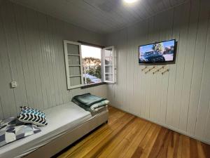 a small room with a bed and a window at Garibaldi Guest House in Garibaldi