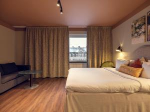 a hotel room with a large bed and a window at Elite Hotel Arcadia in Stockholm